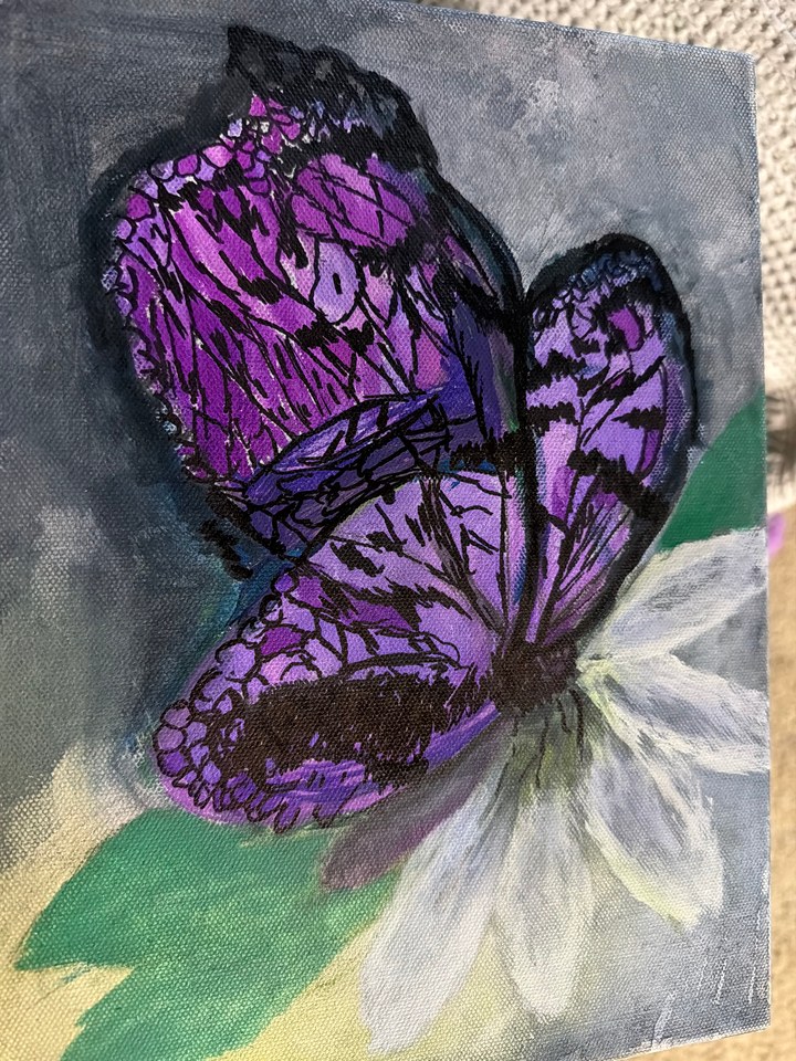 A butterfly I painted, inspired by a photo I had, featured vibrant colors that I enjoyed.